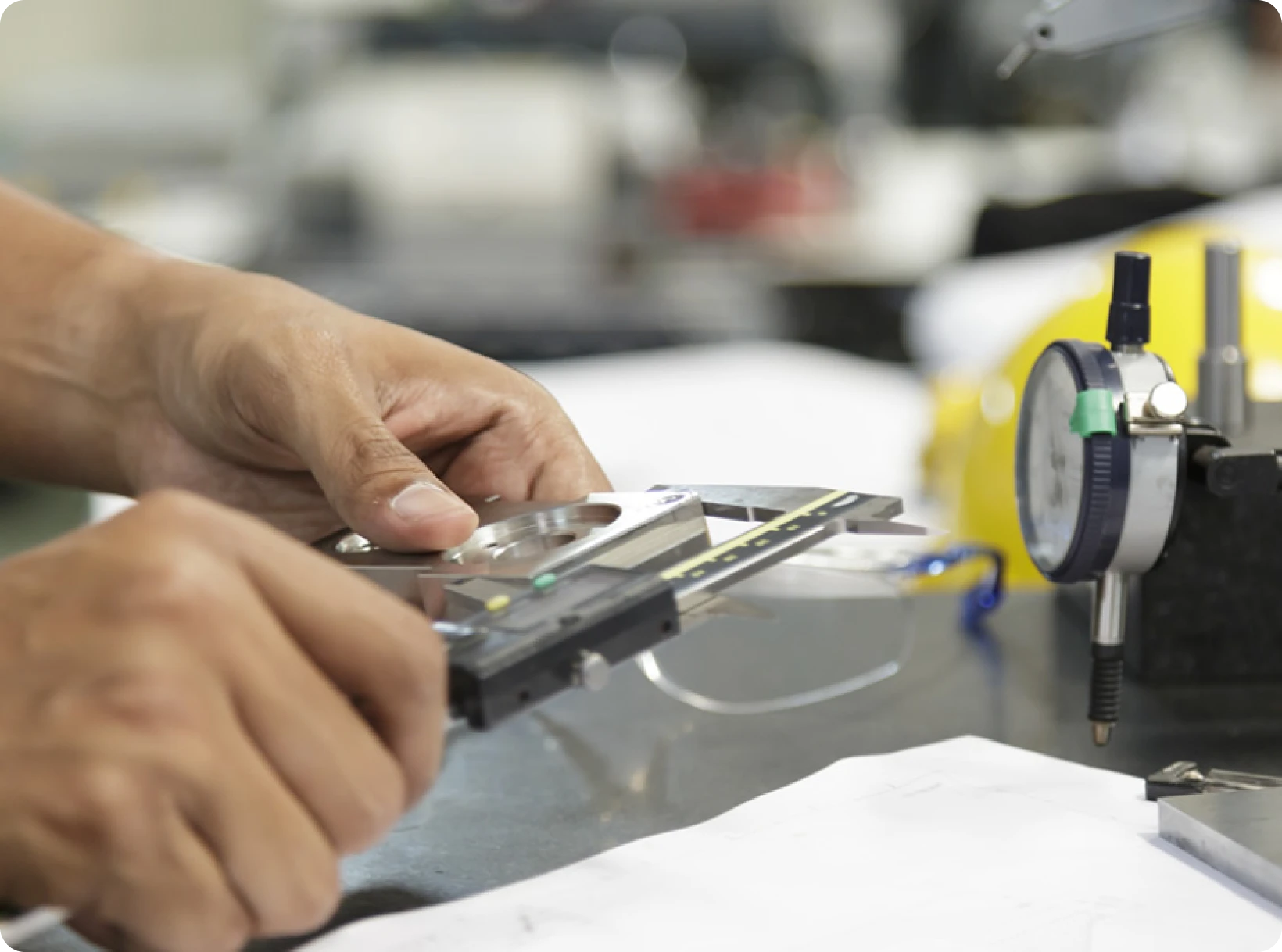 Hands measuring with caliper and gauge