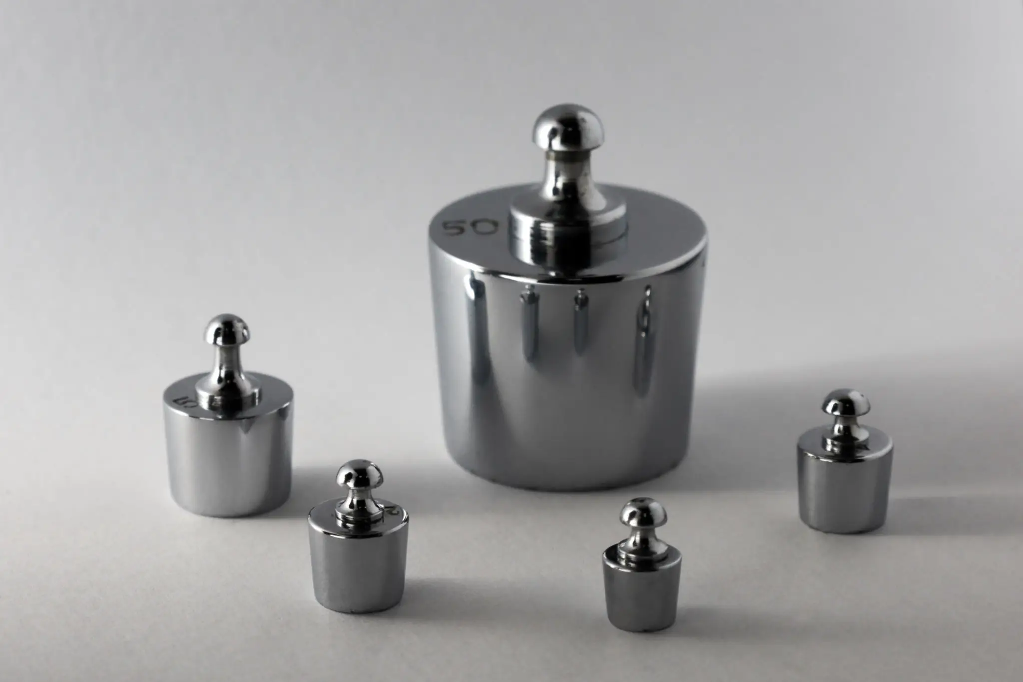 Various sized metal weights on table
